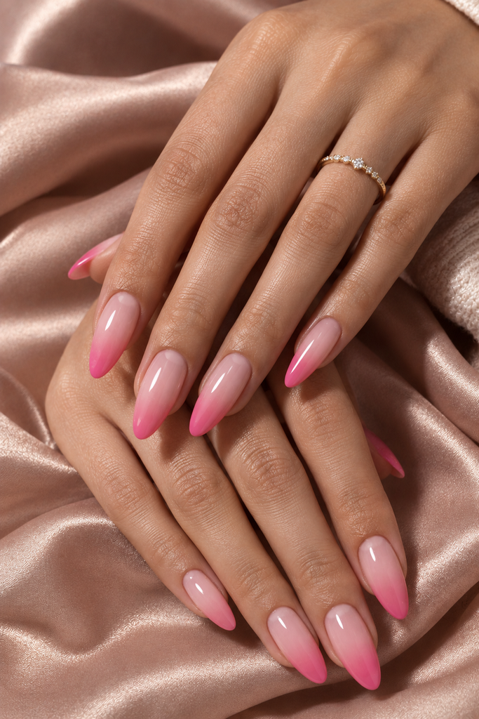 Long almond nails fading from translucent blush pink to vibrant pink tips.