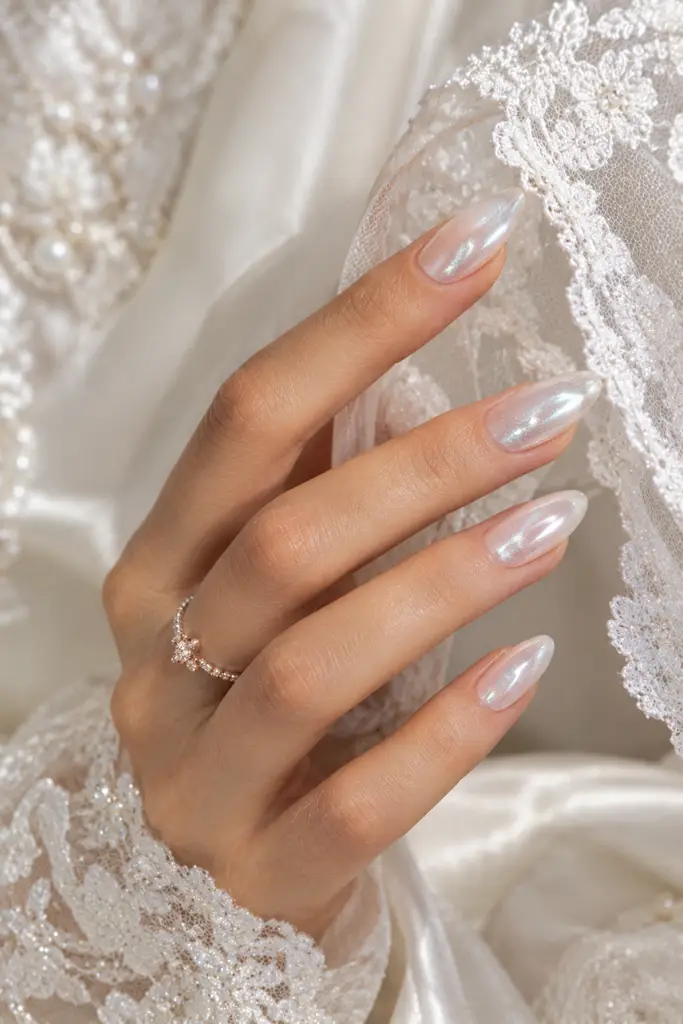 Milky white cat eye nails with pearlescent silver reflections